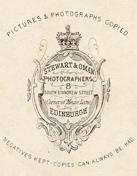 Enlargement of the back of a carte de visite of a young man in a large suit by Stewart & Oman