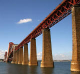 The Forth Rail Bridge covered in scaffolding and partially encapsulated for painting.