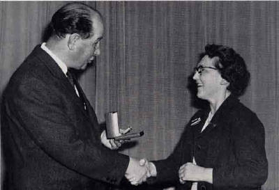EPS President, George Paterson, makes a presentation of a gold watch to  to Grace Alison - 1964