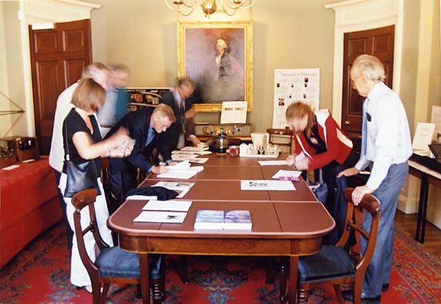 Members of the Scottish Society for the History of Photography (SSHoP) sign the Visitors' Book at the James Clerk Maxwell Museum at James Clerk Maxwell's birthplace - 14 India Street