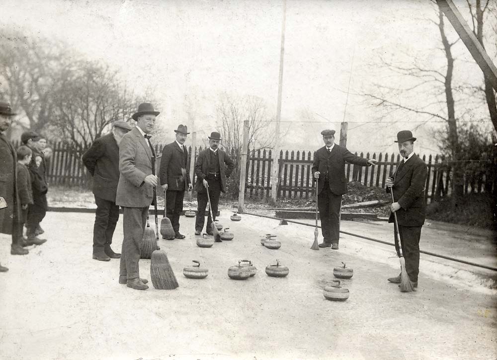 Enlargement of a photograph of an outdoor curling match.  Where and when was it taken?
