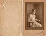 A folder containing a postcard portrait of Nancye Freeman taken in Jerome's Studio