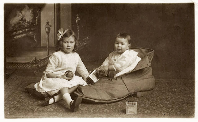 Postcard from Morrison's Studios, 1920  -  Two young children, one siting in a large shoe