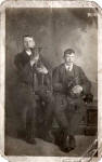 A Photograph of two brothers from Leith with whippets  -  taken in an unidentified studio