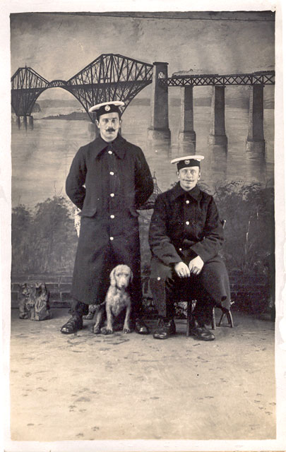 Postcard from McGill's studio, South Queensferry  -  Two sailors and a dog with a backdrop of the Forth Bridge