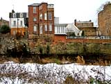 Looking east across the Water of Leith to the backs of the buildings in Dean Bank Lane, Stockbridge  -  December 2009