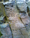 Letternig carved into the rock near the top of Arthur's Seat