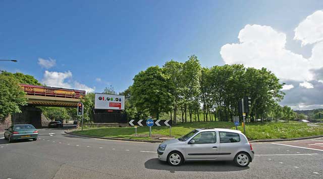 A freight train heading east on the Edinburgh South Suburban Line crosses the roundabout at Cameron Toll, Edinburgh  -  May18, 2008