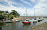 Cramond  -  The former Ferryman's House and boats moored in the River Almond at low tideThe River Almond at Cramond  -