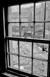 View through the window of one of the houses beside the footbridge over the Water of Leith at Dean Village