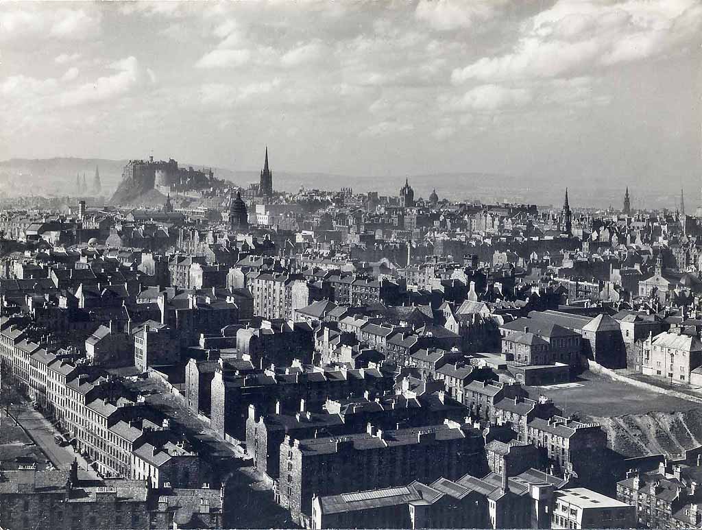 Looking down on Dumbiedykes and out towards Edinburgh Castle from Salisbury Crags  -  probably around the 1950s.