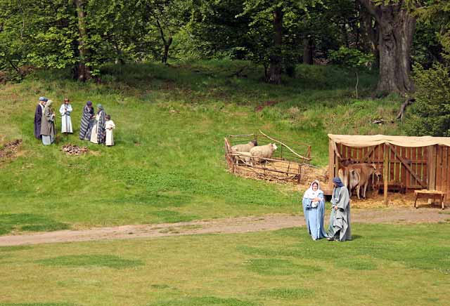 A scene from 'The Life of Jesus Christ' - a play presented at Dundas Castle  -  Mary, Joseph and Jesus outside the stable, with shepherds on the hill