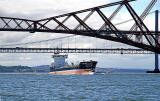 A Tanker heading out to Sea passes under the Forth Bridges