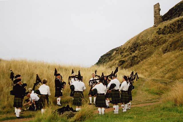 Pipers practice beside Hunter's Bog beneath the ruins of St Anthony's Chapel in Queen's Park, Edinburgh, before joining the ceremony of "Beating the Retreat" on 17 August 2003