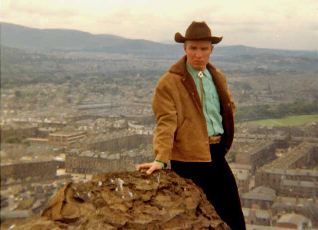 Bob Penry of 'The Gatekeepers' folk group, 1965-66, photographed on Arthur's Seat, Holyrood Park  -  St Leonards district is in the background