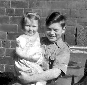 John Stewart and cousin Eveline, on the balcony  car seat given by 'Wingy' Robertson 