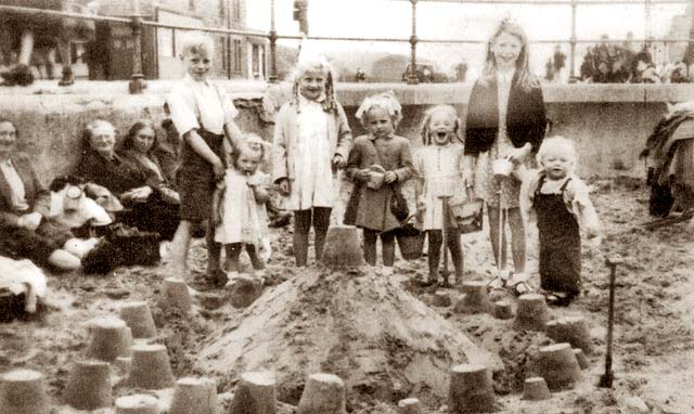 Family and Sand Castle on the beach at the foot of Bath Street, Portobello  -  1945