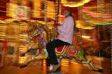 Polina Smirnoff from Moscow on the Galloping Horses Christmas Carousel beside the Scott Monument in East Princes Street Gardens