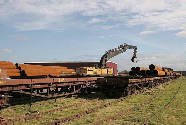 Unloading pipes from at train at Seafield, Edinburgh