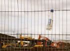 Looking from Granton Middle Pier across the building work at Western Harbour with the one remaining gasometer in the background - with the Irn Bru bottle still wedged into the fence.