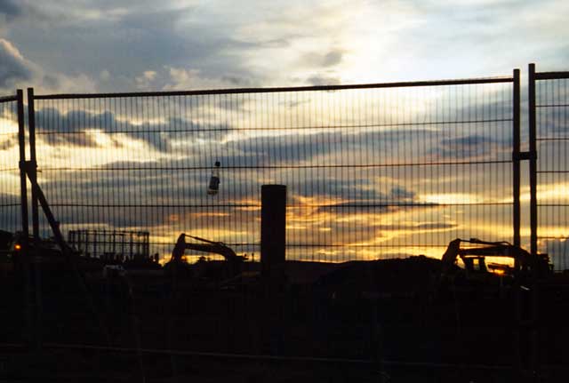 Iron Bru Bottle in the fence separating Middle Pier from the Western Harbour construction site at sunset