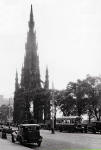 The Scott Monument in Princes Street with two cars and a bus