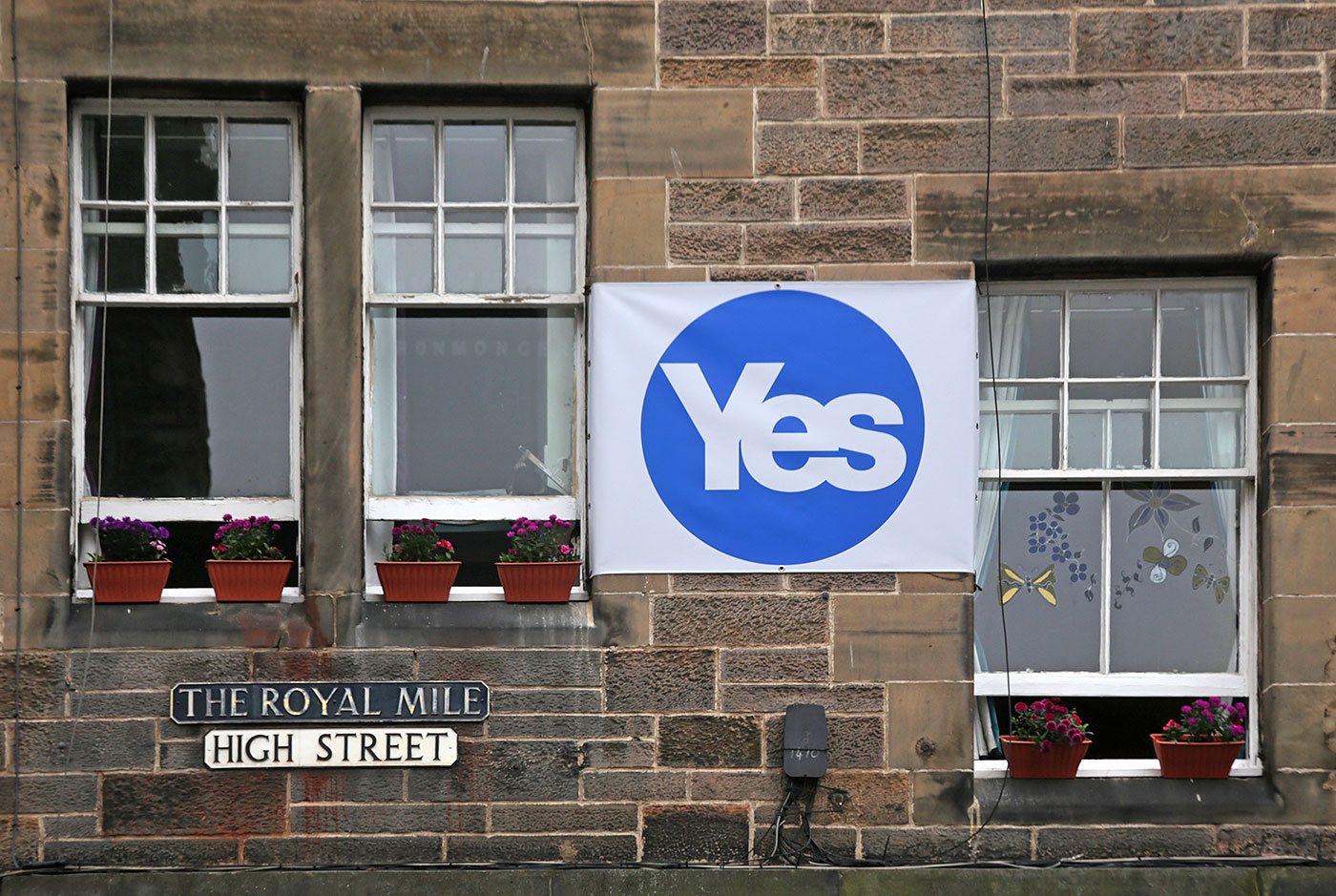 Photos taken in Edinburgh on voting day in the  Scottish Indepemdence Referendum on 18 September 2014  -  The Royal Mile  -  A 'Yes' message on tenements in the High Street