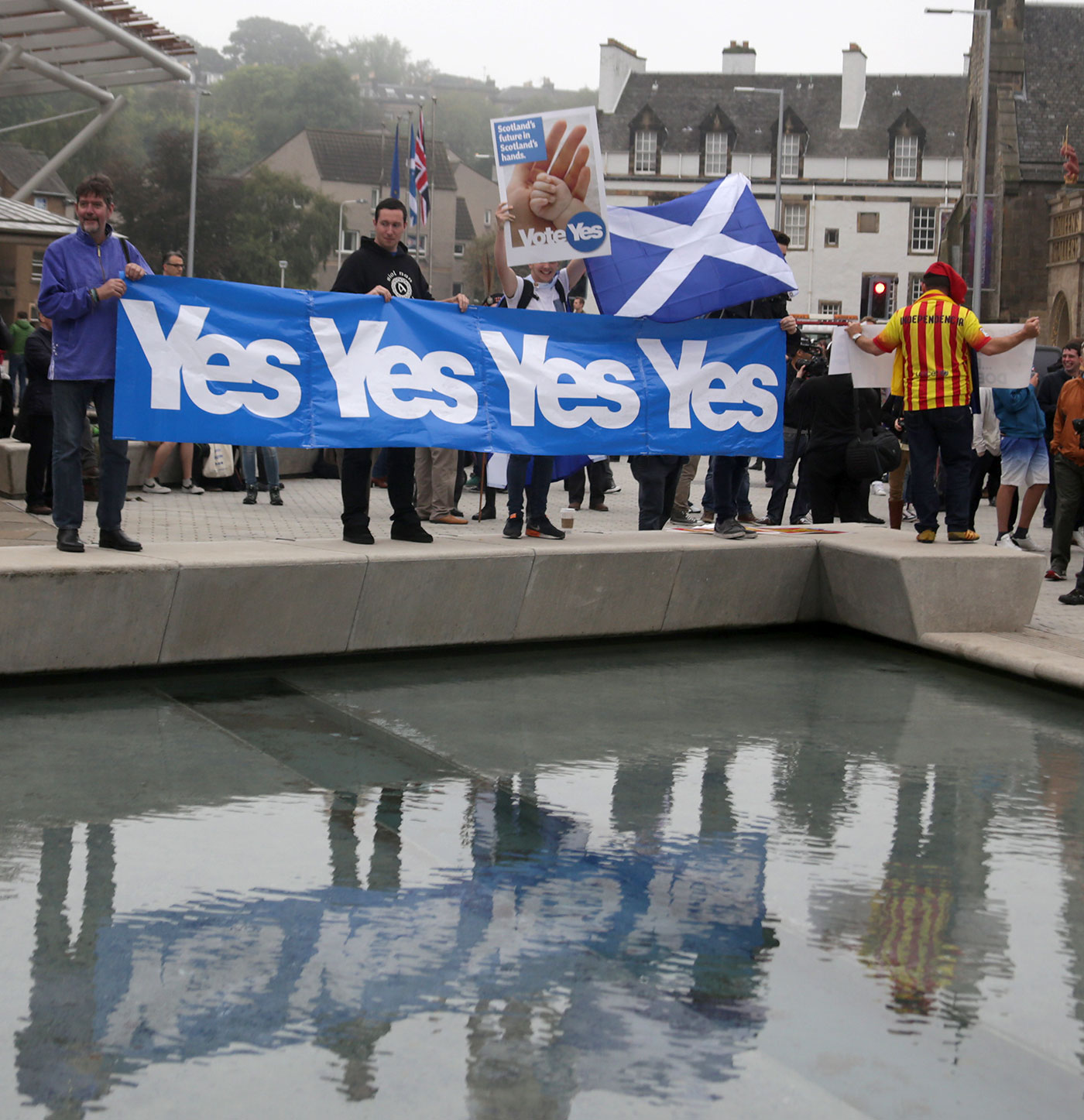 Photos taken in Edinburgh on voting day in the  Scottish Indepemdence Referendum on 18 September 2014  -  Outside the Scottish Parliament  -  Four supporters of the 'Yes' Campaign and one supporter of Independence for the Catalans.