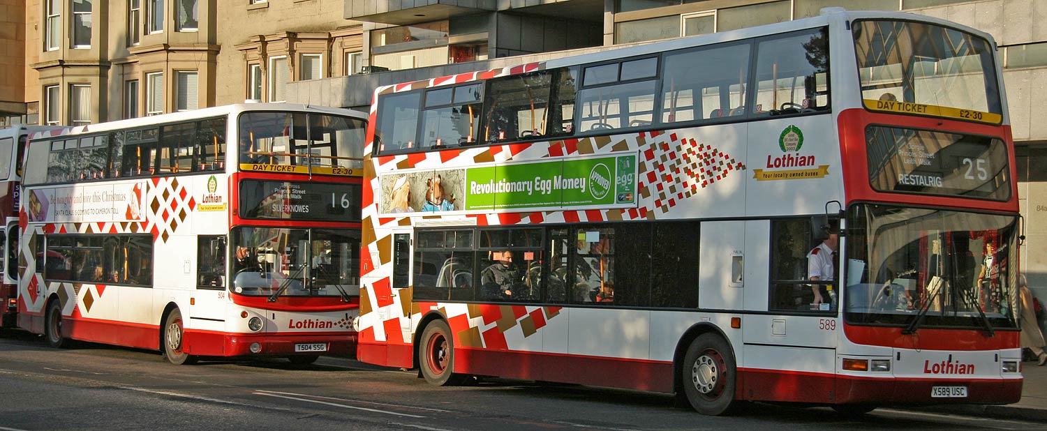 Two buses in Princes Street, showing  older and more recent examples of the Lothian Buses harlequin livery  -  November 2005