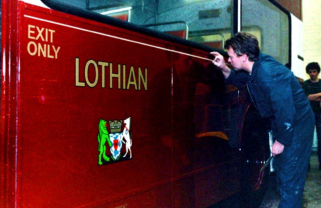 Gold Line being applied to one of the Lothian Buses at the Paintshop at Seafield.Two buses, one a Leyland Titan PD2 being painted at Seafield Paintshop