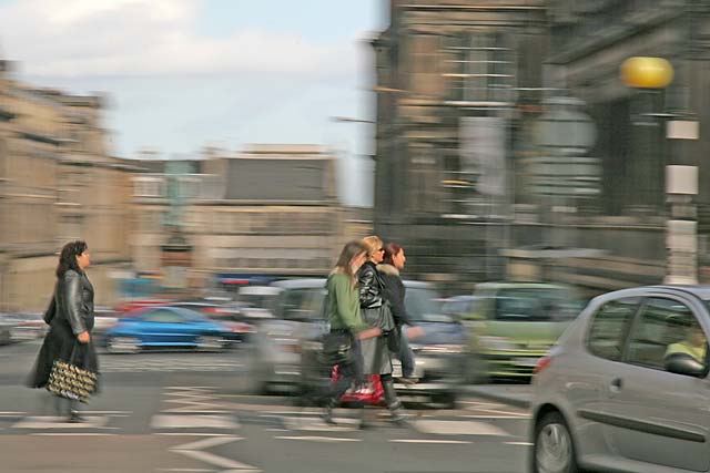 Pedestrians crossing Chambers Street heading towards the National Museum of Scotland