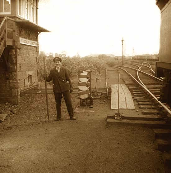 A railway worker stands beside the railway in front of Woodmuir Junction signal box in West Lothian