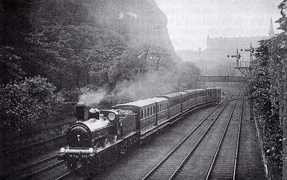 A North British Railway train passes through Princes Street Gardens, approaching Waverley Station