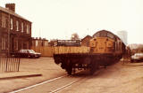 A Class 37 loco and truck passes beside Waugh's Scrap Yard at West Harbour Road, Granton.  This photo was taken, looking west from West Harbour Road, beside Granton Square