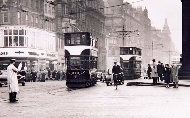 Trams and other traffic in Princes Street at the foot of the Mound