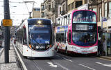 Tram and Bus in Princes Street, mid-March 2014.  The bus is in the branded  livery for Route 22