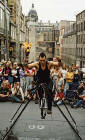 Edinburgh Festival 2003  -  Street Entertainer at Hunter Square  -  A Unicyclist on a Tightrope about to juggle three Flaming Torches