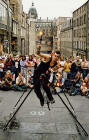 Edinburgh Festival 2003  -  Entertainer at Hunter Square  -  A Unicyclist on a Tightrope juggling three Flaming Torches