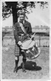 Jimmy Little, a member of Davidson's Mains Pipe Band, in his front garden at 33 Pennywell DFrive in 1950/51