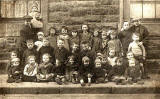 Dumbiedykes  - A group of 30 children and two men, all on the pavement  -  around 1922