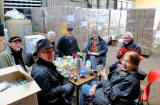 Seven of the workers, packing goods for refugees in Syria take a short lunch brea at the Edinburgh Direct Aid warehouse, 16a West Harbour Road, Granton