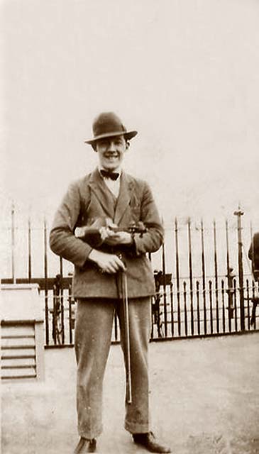 Harry Nolan, busking with his violin in Princes Street