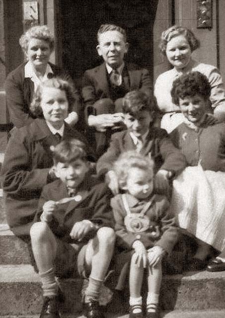 A group of eight on the steps of 5 Keir Street, around 1956