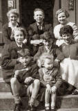 A group of eight on the steps of 5 Keir Street, around 1956