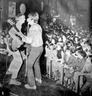 Two of 'The Moonrakers' pop group performing on stage at McGoos in the 1960s