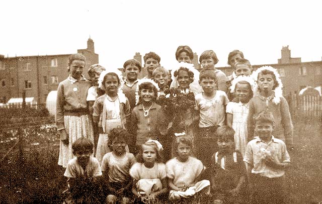 A group of 21 children on the back green behind West Pilton Crossway, 1955