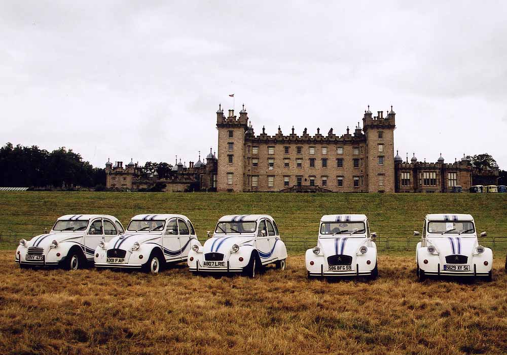 Citroen 2CV cars  in the grounds of Floors Castle,  Kelso, in the Scottish Borders  -  during the World 2CV Meeting held at Kelso, July 2005   -  Large photo