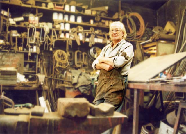 Alexander McLennan with his hammer, in the middle of his blacksmiths workshop at Powderhal
