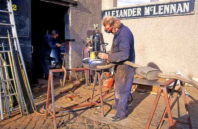 Alexander McLennan at work outside his blacksmith's workshop, Powderhall , Edinburgh