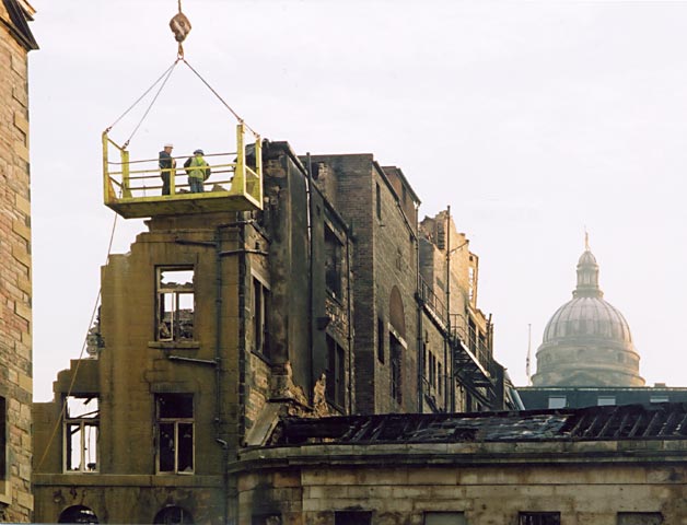 Photograph by Peter Stubbs  -  Edinburgh  -  December 2002  -  Fire in the Old Town of Edinburgh  -  Dismantling the wall in the Cowgate (close-up)
